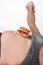 Cropped view of overweight man pointing with finger at burger on belly