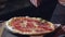 Cropped view pizza with salami and cheese served in restaurant