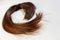 Cropped view of a ponytail cutting hair for donation. Usable hair can turn your long locks into free or low-cost wigs