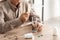 cropped view of retired man with mental illness holding pills.