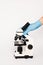 Cropped view of scientist touching microscope