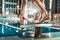 cropped view of swimmer standing on diving board ready to jump into competition