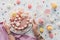 cropped view of tattooed hands with pink birthday cake candies sweet cupcakes and milkshakes on marble