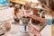 cropped view of woman decorating ceramic bowl in pottery