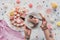 cropped view of woman holding fork and plate with piece of pink birthday cake