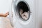 cropped view of woman opening washing