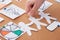 Cropped view of woman pinning paper craft decoration on cork board.