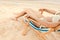 cropped view of woman relaxing on beach chair