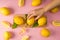 cropped view of woman taking lemon with little ladder from wooden board on pink background