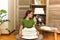 Cropped view of the woman wearing green t-shirt near cupboard holding towels in laundry room