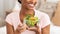 Cropped view of young black lady eating fresh vegetable salad indoors, panorama