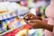 Cropped view of young black woman checking grocery list app on cellphone at supermarket, copy space