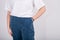 Cropped view of young woman in white oversize T-shirt and dark blue pants isolated on white. Fashion clothes  streetstyle concept