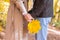 Cropped of woman holding bunch of golden leaves and man