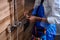 Cropped young afro american plumber man repairing fixing faucet in shower stall