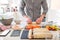 Cropped young caucasian man making sushi at home following cooking online video classes on website via smartphone. Internet