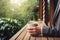 Cropper view of A businessperson holding a coffee cup stands on a wooden porch. AI Generated
