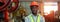 Cropping image banner size, engineering black male African American workers wear red helmet arm crossed pose standing at machine