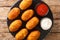 Croquetas de Bacalao Cod Croquettes with sauces close up in the slate plate . Horizontal top view