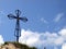 The cross on the background of clear sky at the top Biaklo (or M