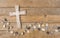 Cross background with wave of stones on wood
