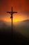 Cross with beautiful sunset with fog. Czech landscape with cross with orange sun and clouds during morning. Hilly mystic landscape