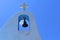 A cross and a bell on a Greek Orthodox church in Peloponnese.