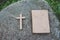 The cross and the bible is on the rock, sins and prayer.