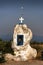 Cross on a big boulder by road, Greece