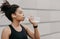 Cross, cardio training and healthy lifestyle. Muscular african american girl with modern headphones and fitness tracker