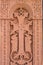 Cross carved on red stone - armenian church