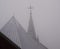 A cross from a church in the mist