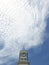 Cross on Clock tower with Cirrocumulus cloud and sky background