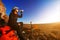 Cross country biker drinking water with bike, sky background. side view