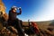 Cross country biker drinking water with bike, sky background. side view