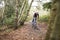 Cross-country cyclist riding on a forest trail, front view