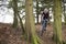 Cross-country cyclist riding between trees, front view