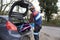 Cross-country cyclist taking bike out of the back of his car