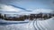 Cross country skiing. Empty touring ski trail. Snowy mountains in the background