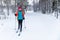 Cross country skiing - woman with skis on snowy forest ski track. Akaslompolo, Finland