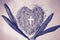 Cross or crucifix in heart shaped ash with palm leaves. Purple, monochromatic. Lent Season, Holy Week, Palm Sunday and Good Friday