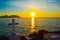 A cross dedicated to the death of sailor Pepe Ruiz in Punta Robaleira, Cabo Home, Spain. Beautiful sunset over the sea and rocks