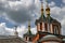 Cross-driven cathedral in Kolomna Kremlin from red bricks with golden domes and crosses. Russian Orthodox Church