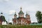 Cross-driven cathedral in Kolomna Kremlin from red bricks with golden domes. Russian Orthodox Church