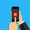 Cross icon in smartphone screen. Hand hold phone with button of wrong, delete and correct. Red x mark on mobile app. Cellphone