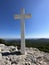 The Cross of Jesus rises on the mountain. Big cross against the background of the sea. Croatia,