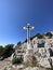 The Cross of Jesus rises on the mountain. Big cross against the background of the sea. Croatia,