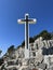 The Cross of Jesus rises on the mountain. Big cross against the background of the sea. Croatia, Ugljan island, near the ruins of