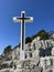 The Cross of Jesus rises on the mountain. Big cross against the background of the sea. Croatia, Ugljan island, near the ruins of