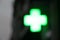 Cross of light of a pharmacy, blurred